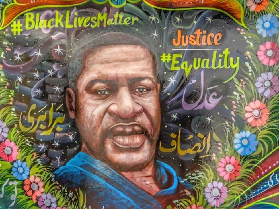 Pakistani truck artist painted a mural depicting George Floyd surrounded by a colorful heart-shaped garland of flowers, with slogans such as #Black Lives Matter on one side and #justice and #equality on the other.Haider Ali